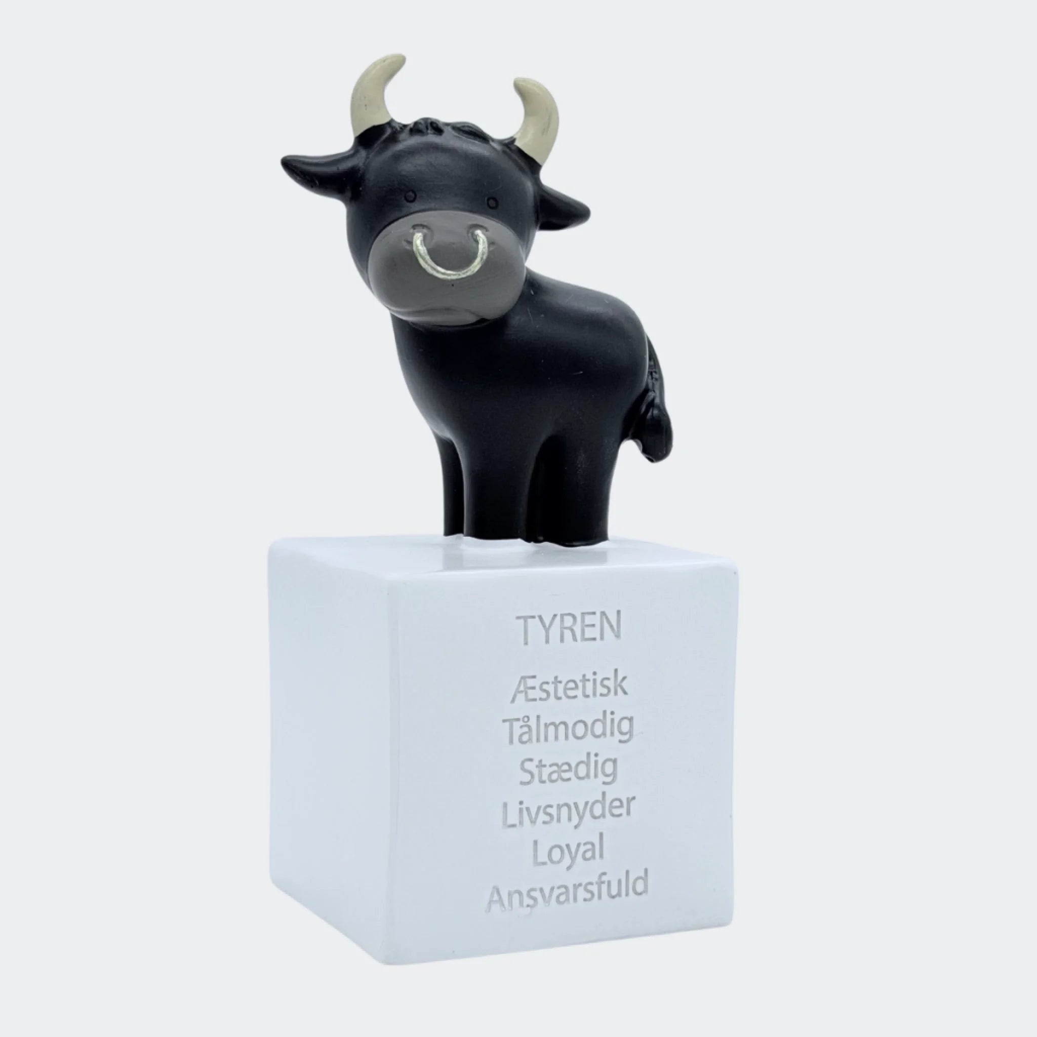 Sort tyrefigur på hvid sparebøsse med Tyren-tekst