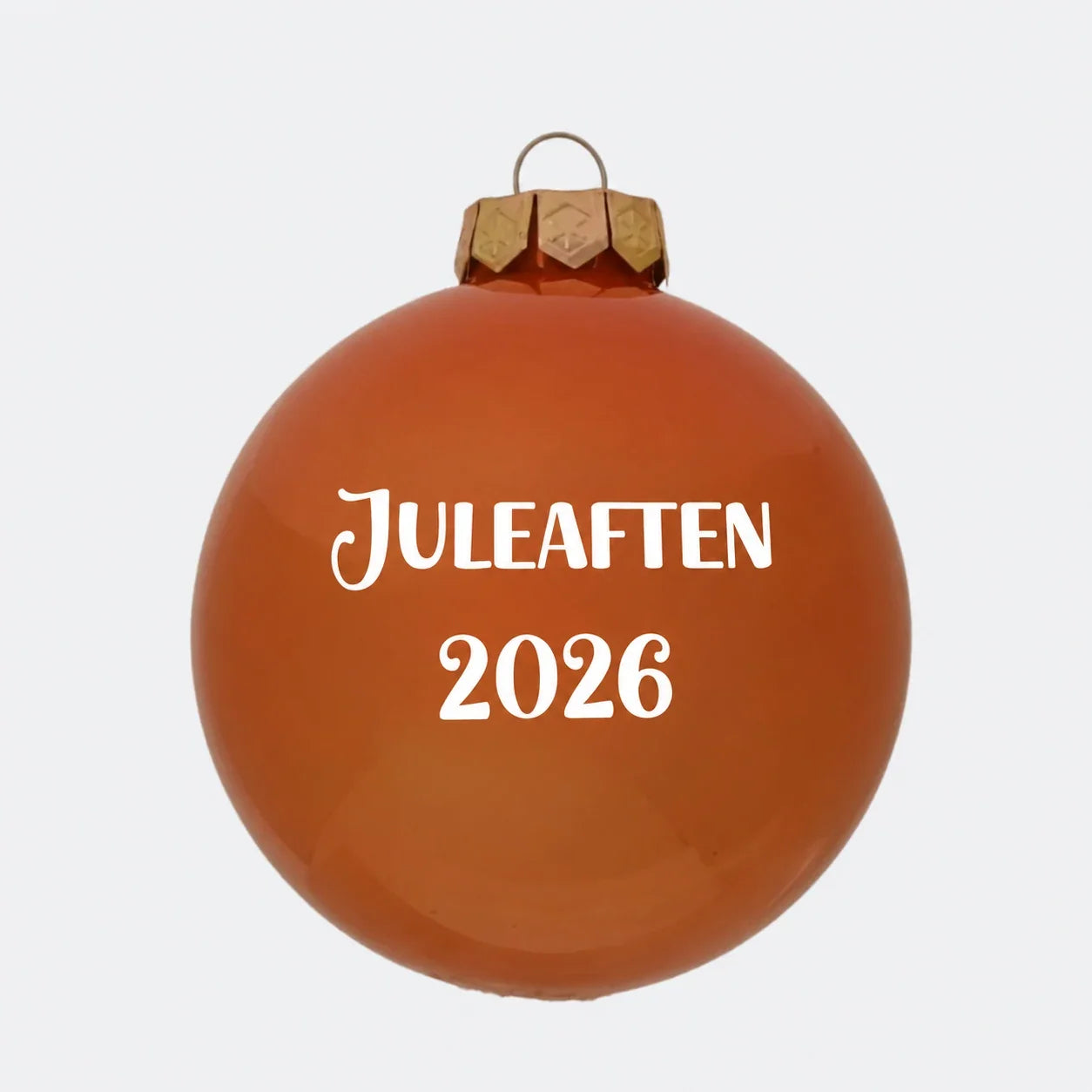 Orange julekugle med teksten Juleaften 2026