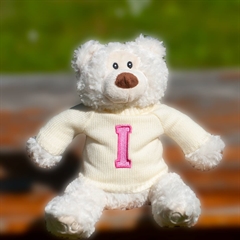 Creme signatur bamse i trøje med pink bogstav